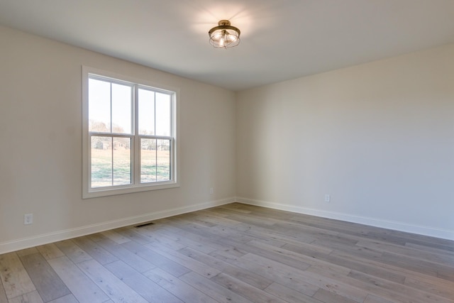 spare room with light wood-type flooring