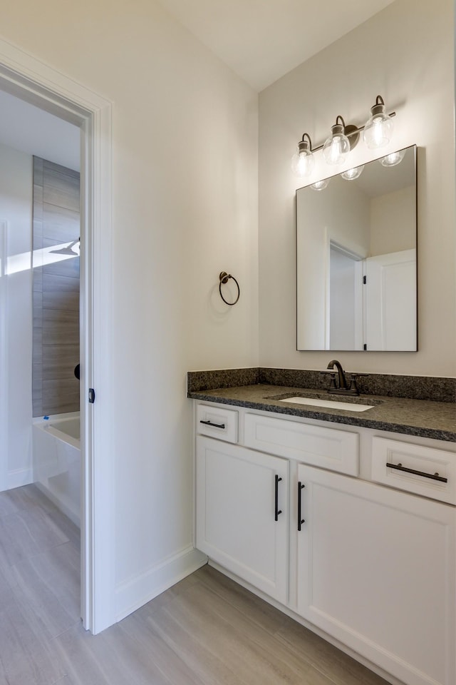 bathroom featuring vanity, wood-type flooring, and shower / bathing tub combination