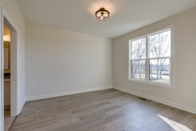 empty room with light hardwood / wood-style flooring