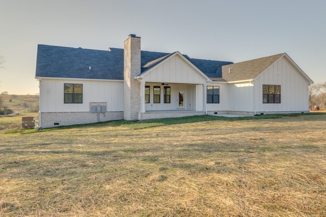 rear view of house featuring a patio area, central air condition unit, and a lawn