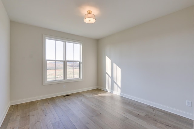 spare room featuring light hardwood / wood-style flooring