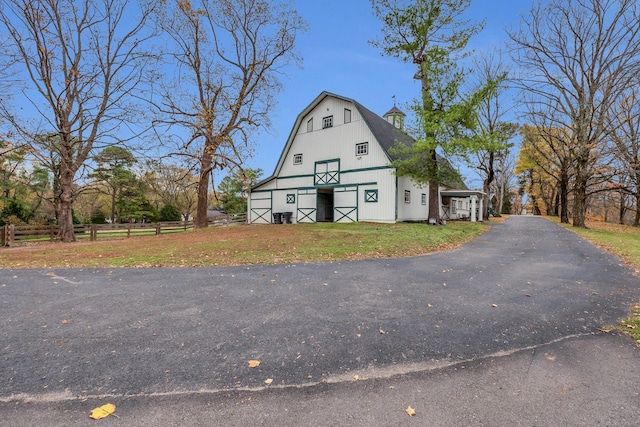 view of front facade with an outbuilding and a front yard