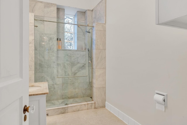 bathroom with tiled shower and vanity