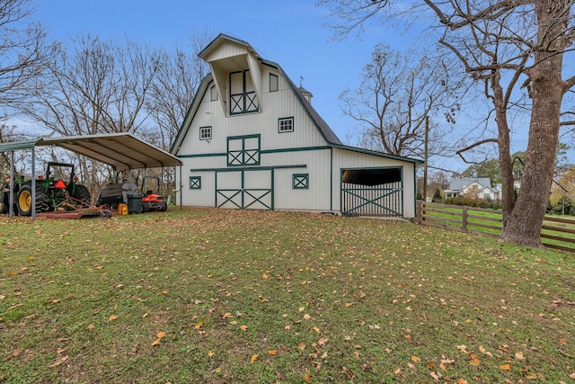 view of outbuilding featuring a carport and a yard