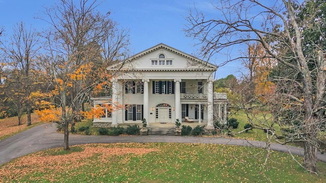 neoclassical home featuring covered porch