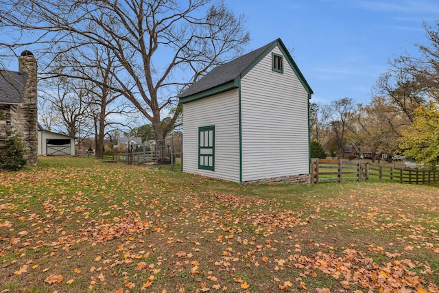 view of outbuilding featuring a lawn