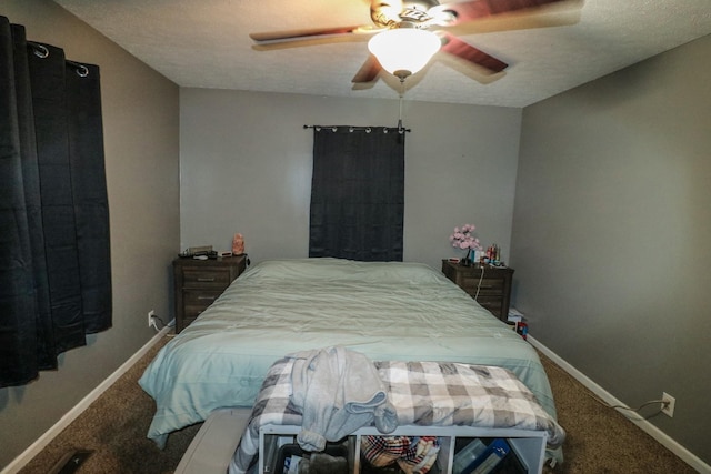 bedroom featuring ceiling fan, carpet flooring, and a textured ceiling