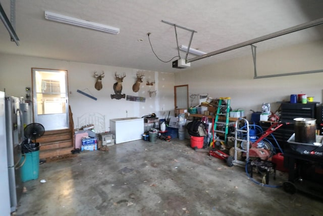 garage with stainless steel refrigerator and a garage door opener