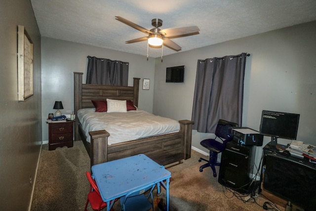 carpeted bedroom featuring ceiling fan and a textured ceiling