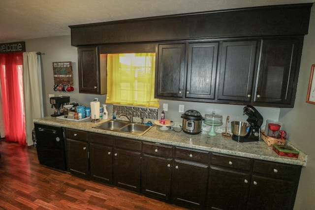 kitchen with dark brown cabinets, sink, and dark hardwood / wood-style flooring