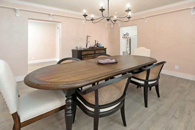 dining space with ornamental molding and light wood-type flooring