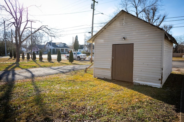 view of outdoor structure featuring a lawn