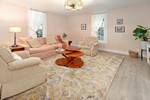 living room with plenty of natural light and light hardwood / wood-style flooring