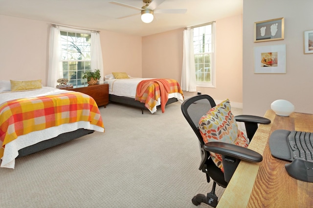 carpeted bedroom with ceiling fan and multiple windows