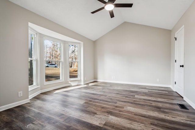 spare room with lofted ceiling, dark wood-type flooring, and ceiling fan