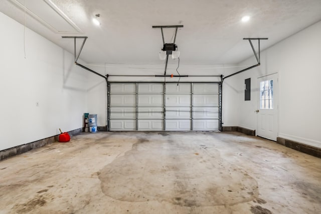 garage with a garage door opener and electric panel