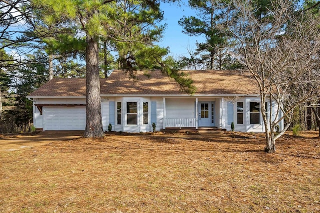 ranch-style house with a garage and a porch