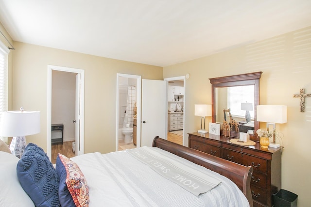 bedroom with connected bathroom and sink