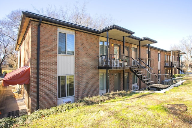 rear view of property featuring a lawn