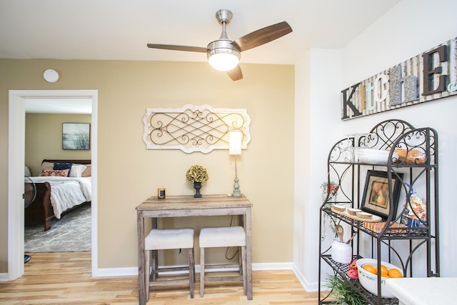 corridor featuring light wood-style floors and baseboards