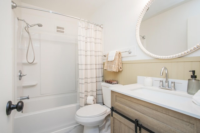 full bathroom featuring toilet, vanity, visible vents, wainscoting, and shower / bath combo with shower curtain