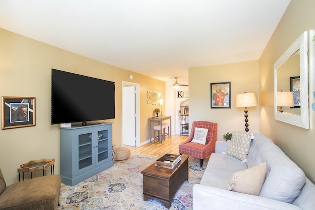 living area featuring ceiling fan and wood finished floors