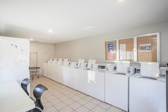 shared laundry area featuring light tile patterned floors, washing machine and dryer, and recessed lighting