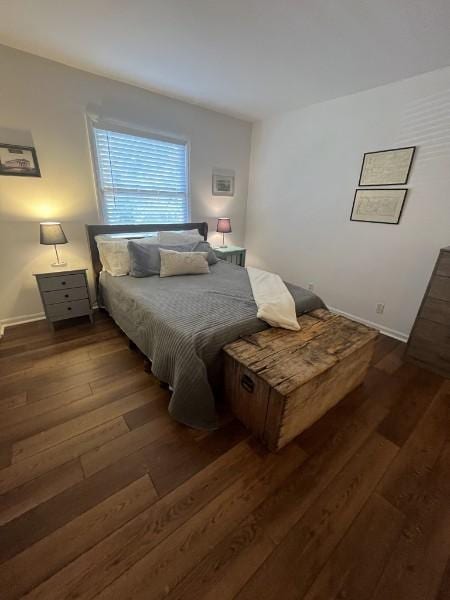 bedroom with dark hardwood / wood-style flooring