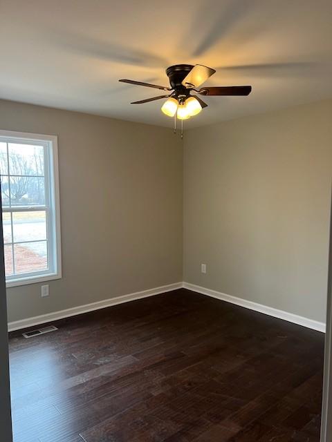 spare room featuring ceiling fan and dark hardwood / wood-style floors