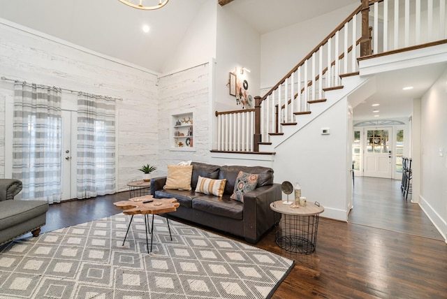 living room featuring dark wood-type flooring, high vaulted ceiling, and french doors