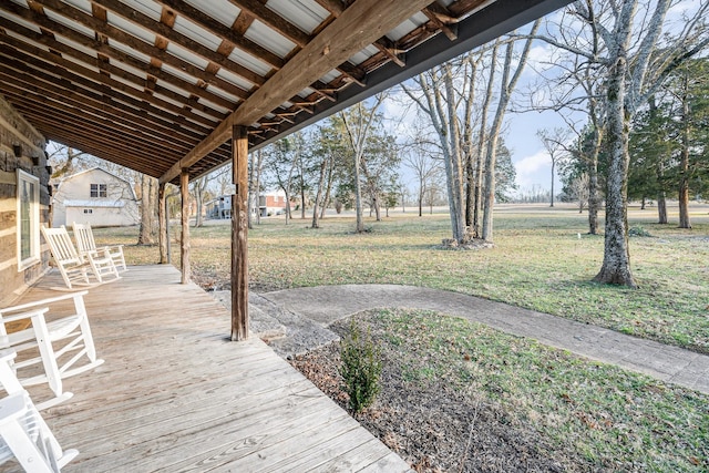 wooden terrace with a lawn