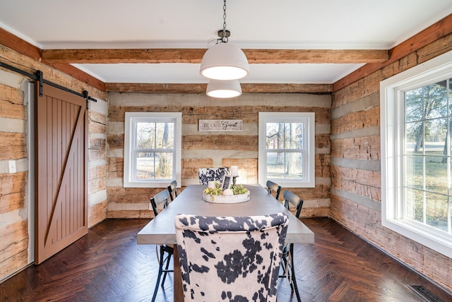 dining area featuring beam ceiling, dark parquet floors, a barn door, and a healthy amount of sunlight