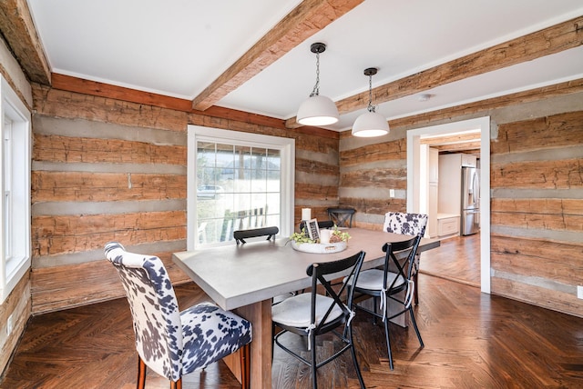 dining space with beamed ceiling, dark parquet floors, and wood walls