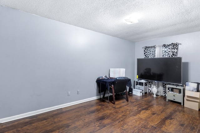 home office with baseboards, a textured ceiling, and hardwood / wood-style floors