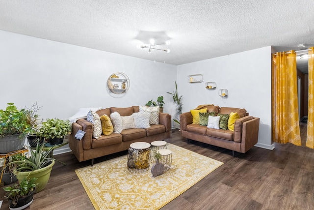 living area with a textured ceiling and wood finished floors