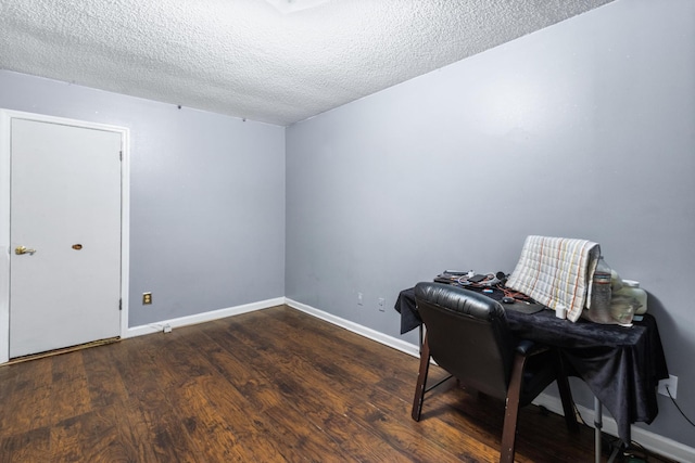 office space featuring a textured ceiling, wood finished floors, and baseboards