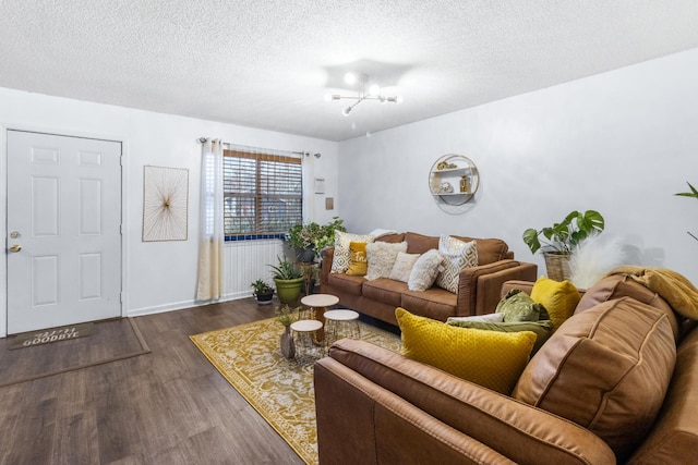 living room with a textured ceiling and wood finished floors