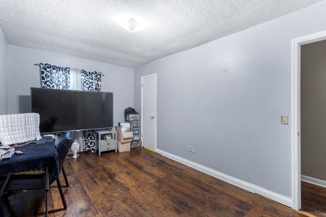 office with a textured ceiling, baseboards, and wood finished floors