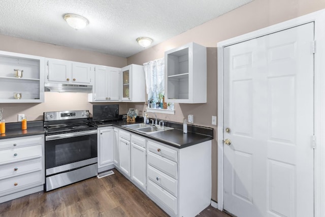 kitchen with under cabinet range hood, a sink, white cabinets, electric stove, and dark countertops