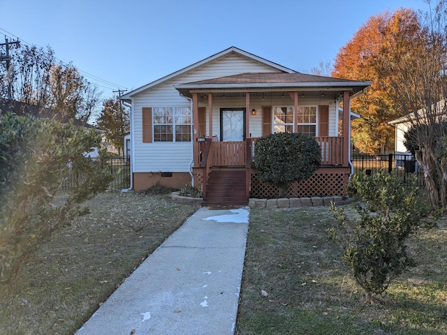 bungalow-style house featuring a shingled roof, crawl space, and covered porch