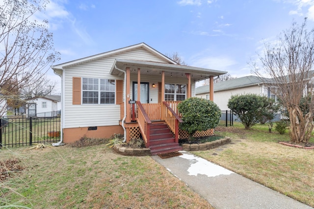 bungalow featuring crawl space, covered porch, fence, and a front lawn