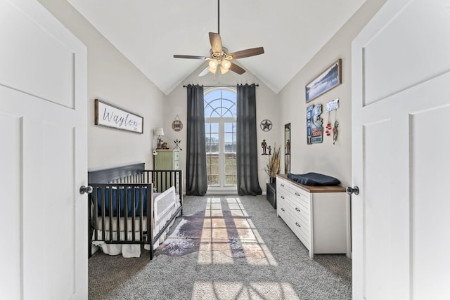 carpeted bedroom featuring lofted ceiling and a crib