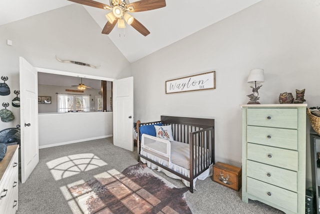 bedroom with a nursery area, high vaulted ceiling, and dark colored carpet