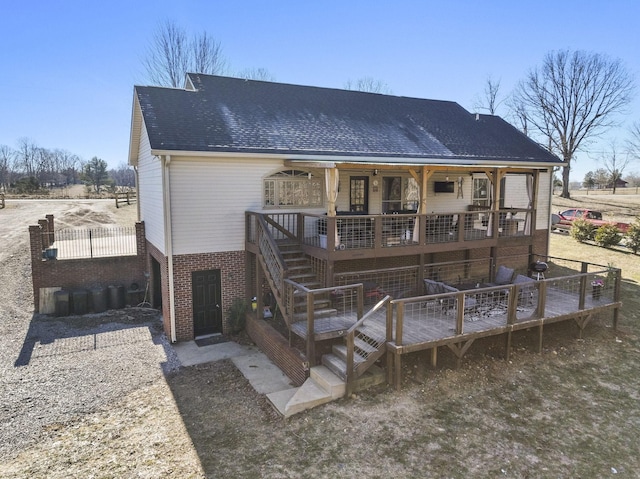 rear view of property featuring a wooden deck