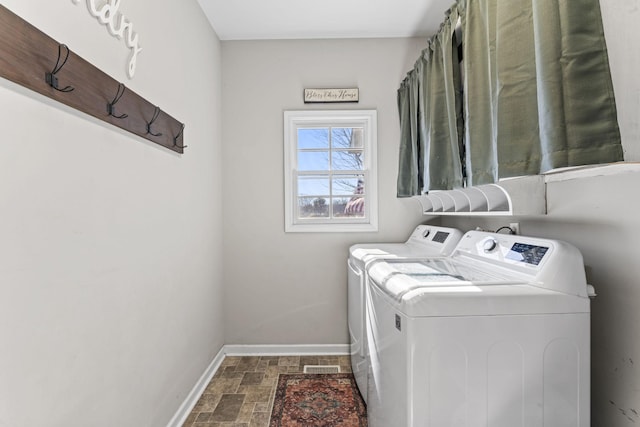 washroom with washing machine and clothes dryer