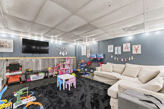 recreation room with carpet floors and a drop ceiling