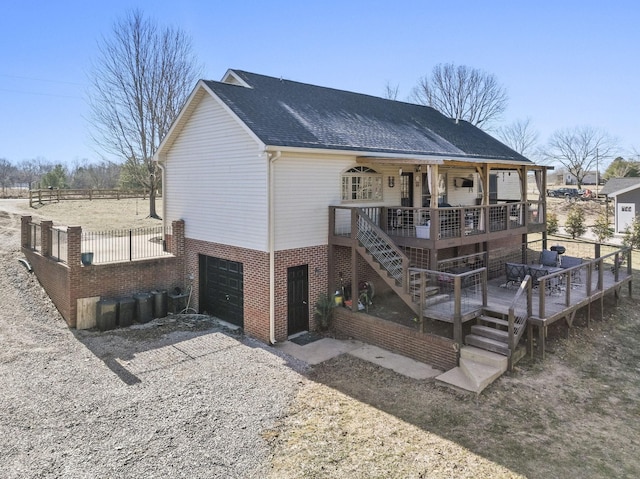 back of house featuring a wooden deck and a garage