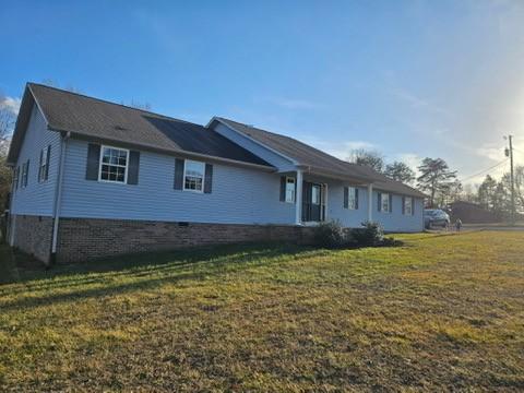 rear view of house with a yard