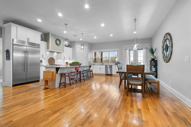 dining space with light hardwood / wood-style floors