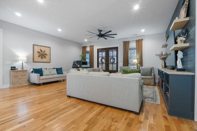 living room featuring french doors, ceiling fan, and light hardwood / wood-style flooring